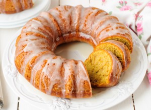 Sliced Pumpkin Bundt Cake with Sugar Icing on a White Plate