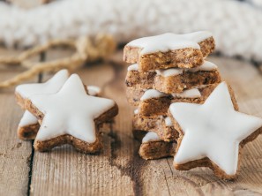 Pile of christmas cinnamon star cookies on wooden table, closeup