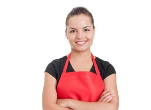 Confident cute employee on supermarket standing with folded arms and smiling isolated on white with copyspace